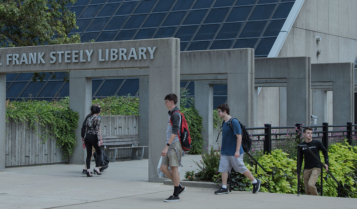Students walking on NKU's campus outside the Steely Library.