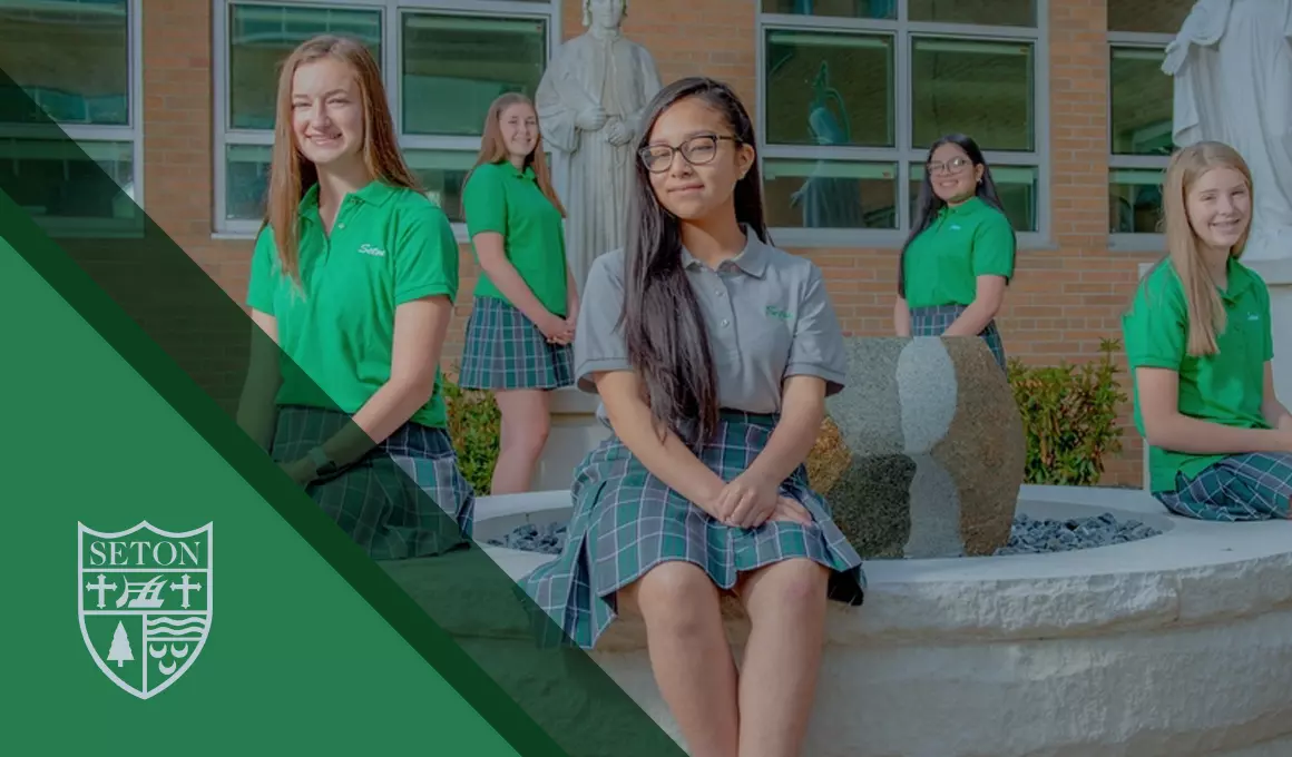 Seton high school's crest is shown with five confident female students gathered around religious statues on Seton's campus. All are dressed in uniform, with polos and plaid skirts. 
